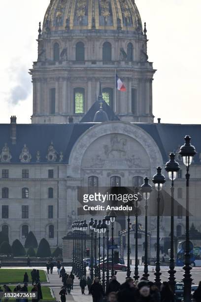 People walk on Esplanade des Invalides in Paris, France on December 08, 2023.