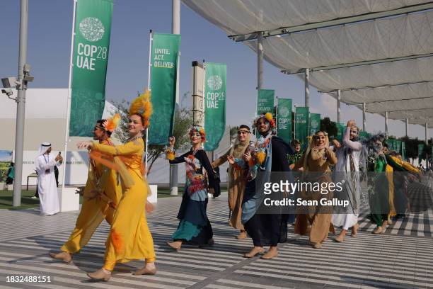 Performers dance in a parade in the Green Zone on day six of the UNFCCC COP28 Climate Conference at Expo City Dubai on December 05, 2023 in Dubai,...
