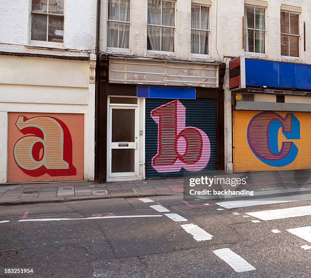 store shutters letters - london street stockfoto's en -beelden