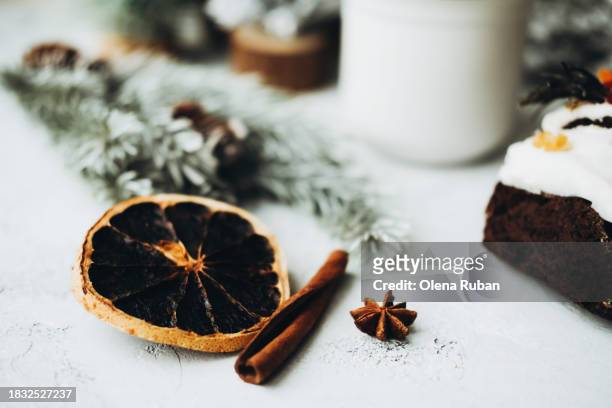 dried orange slice, cinnamon, xmas cake and spruce twig with cones. - lob wedge stock-fotos und bilder
