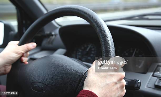 driving a car - hand steering wheel stock pictures, royalty-free photos & images