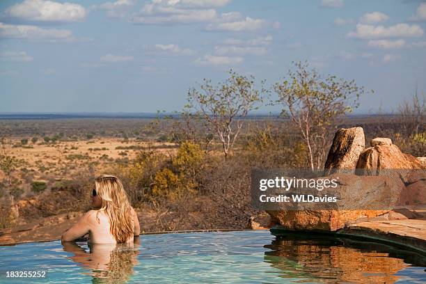 girl in safari lodge pool - safari lodge stock pictures, royalty-free photos & images