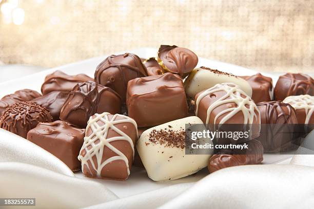 chocolate collection on a silk ackground - chocolate truffle stock pictures, royalty-free photos & images