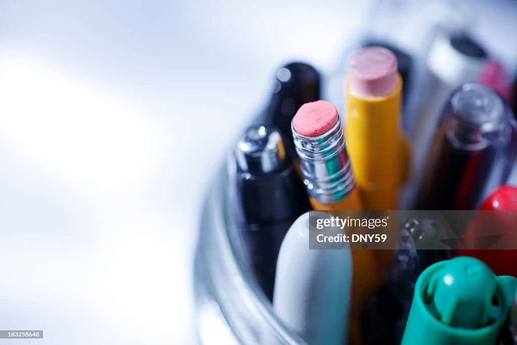 Close up of pens and pencils in a jar