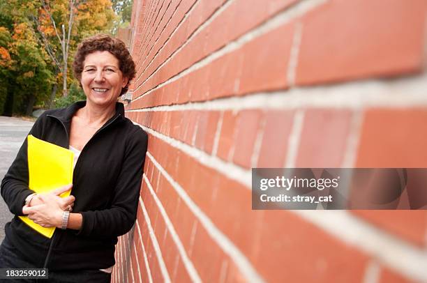 woman with folder outside - teacher with folder stock pictures, royalty-free photos & images