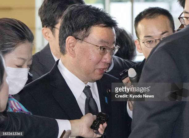 Japanese Chief Cabinet Secretary Hirokazu Matsuno is surrounded by reporters at the premier's office in Tokyo on Dec. 8 having been accused of...