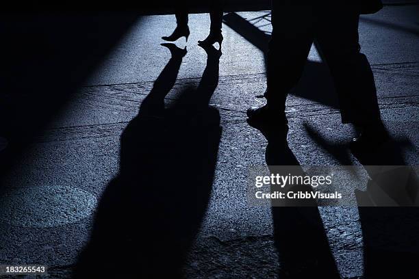male following female into blue night shadows - spooky street stock pictures, royalty-free photos & images
