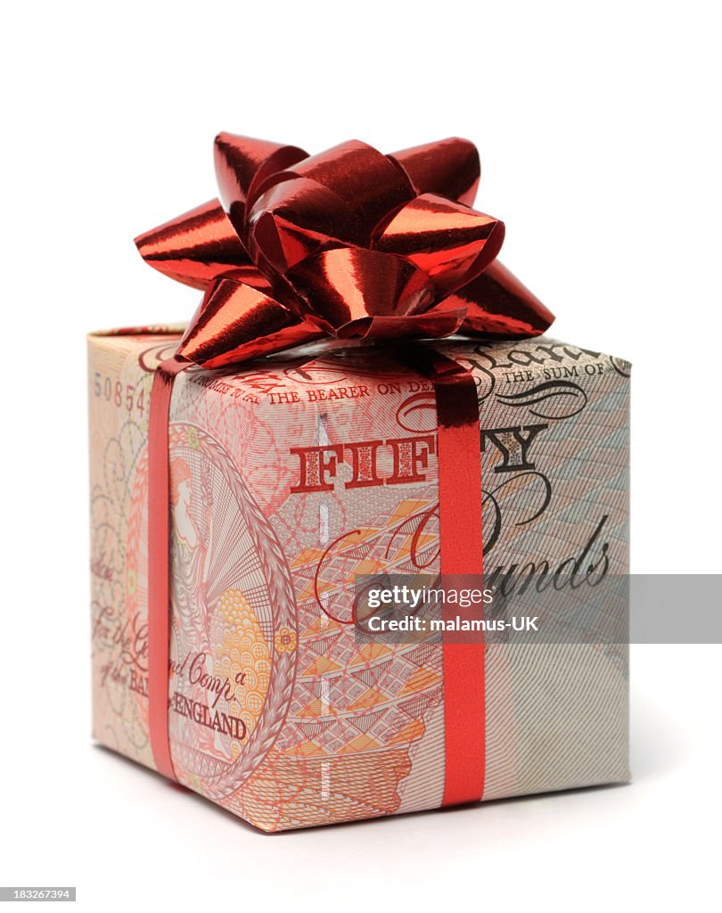 Gift box wrapped in an English pound with a red bow