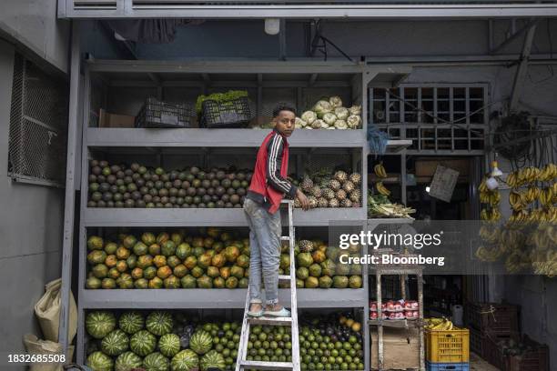 Vendor arranges fruit and vegetables at a stall in Addis Ababa, Ethiopia, on Thursday, Dec. 7, 2023. The Horn of Africa nation has been seeking to...