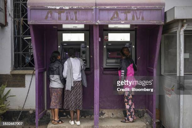Customers use automatic teller machines outside a branch of the Commercial Bank of Ethiopia in Addis Ababa, Ethiopia, on Thursday, Dec. 7, 2023. The...
