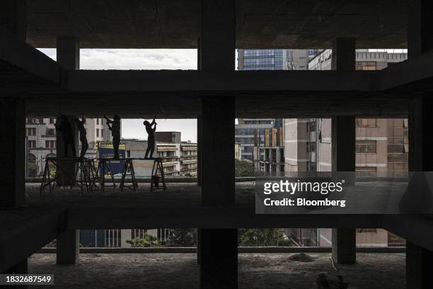 Construction workers scrape a concrete wall on a commercial building site in Addis Ababa, Ethiopia, on Thursday, Dec. 7, 2023. The Horn of Africa...