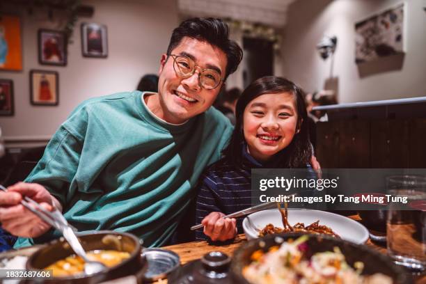 dad & daughter enjoying meal in a korean restaurant - korean food stock pictures, royalty-free photos & images