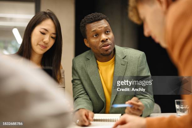 close-up of multiracial people attending business meeting - male office worker stock pictures, royalty-free photos & images