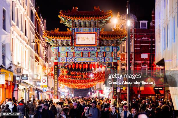 chinatown neighbourhood with crowds of tourists in the evening, london, uk - foreign language stock pictures, royalty-free photos & images