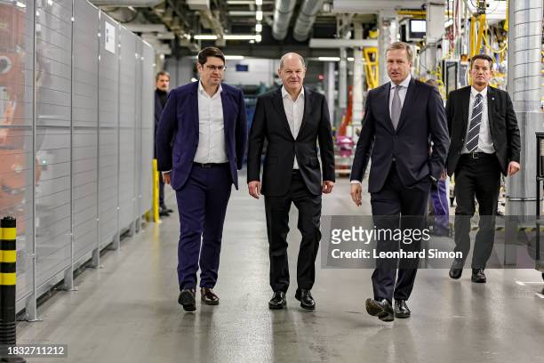 German Chancellor Olaf Scholz walks at the body shop finish and chats with Oliver Zipse, CEO of BMW and Martin Kimmich, head of the working council ,...