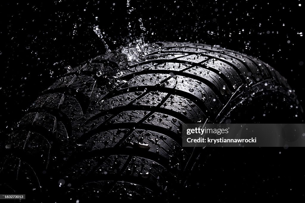Water splashing on a new tire during the rain