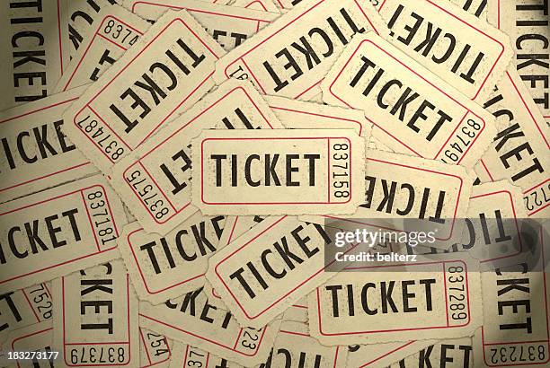 a pile of several white, black and red ticket stubs - ticket stockfoto's en -beelden