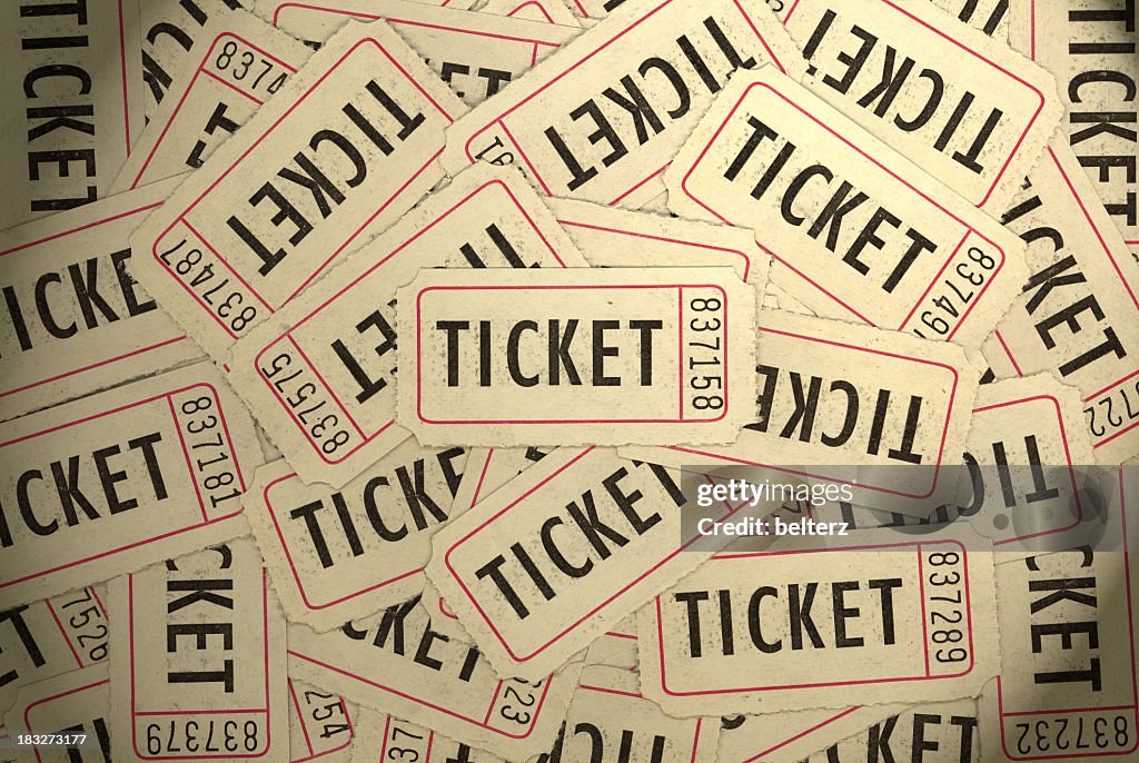 A pile of several white, black and red ticket stubs