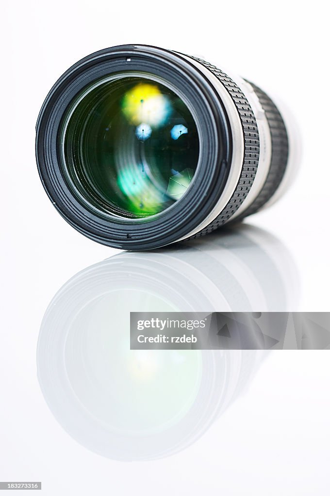 A single camera photo lens reflecting on the surface