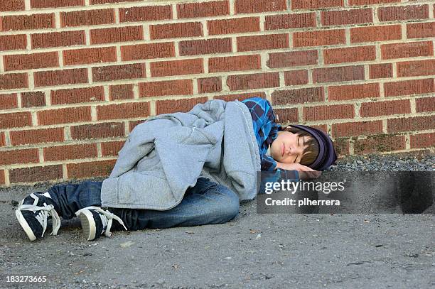 runaway teenage boy asleep in alley - street child stock pictures, royalty-free photos & images