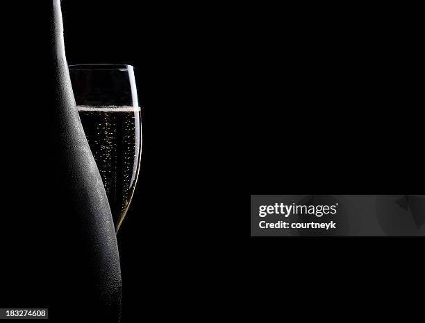 glass and bottle of champagne - champagne glass stockfoto's en -beelden