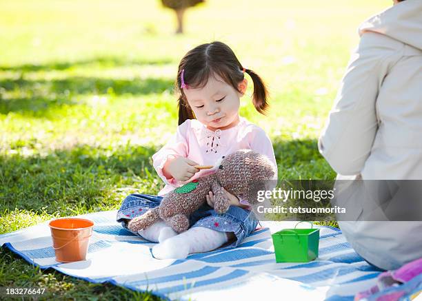 little girl hugging a stuffed toy - teddy bear stock pictures, royalty-free photos & images