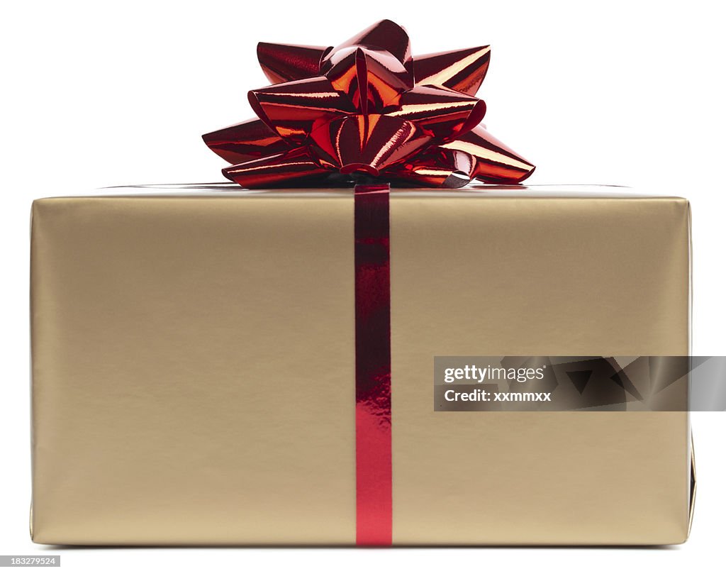 Gold gift box rapped in red ribbon