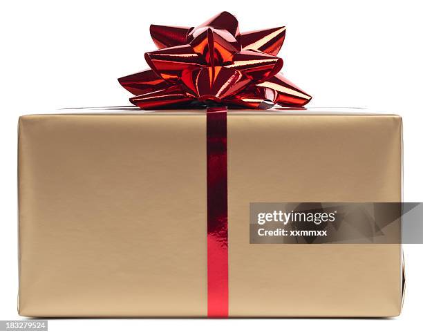 gold gift box rapped in red ribbon - christmas present isolated stock pictures, royalty-free photos & images