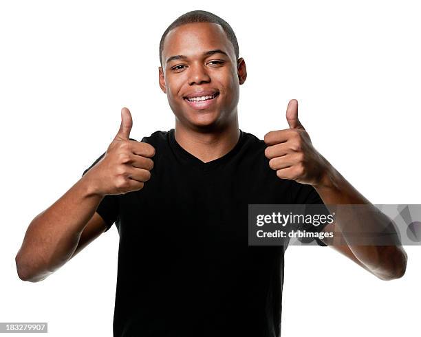 glückliche junge mann gibt daumen nach oben - black thumbs up white background stock-fotos und bilder
