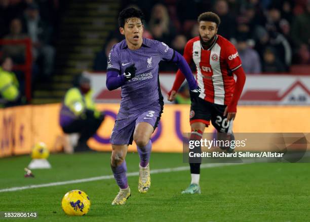 Wataru Endo of Liverpool and Jayden Bogle of Sheffield United in action during the Premier League match between Sheffield United and Liverpool at...