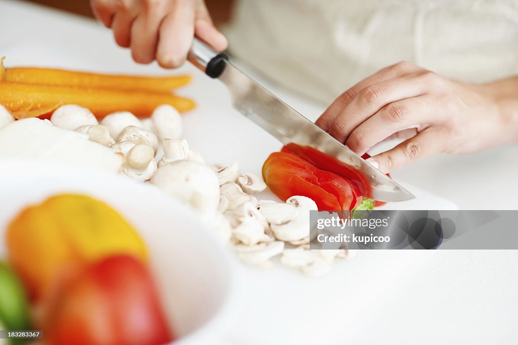 Female hands chopping vegetables in the kitchen