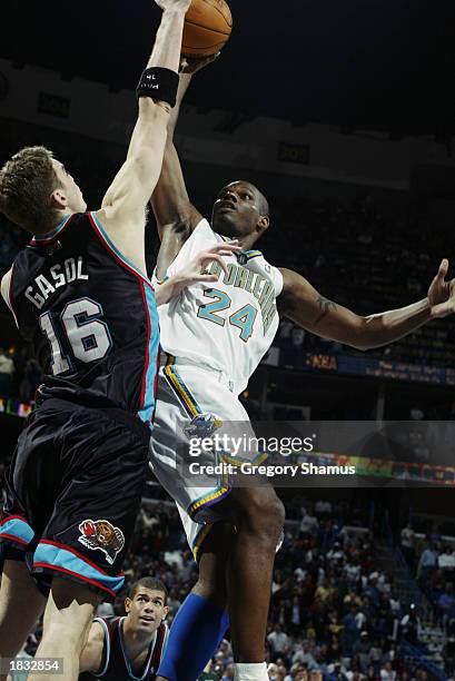 Jamal Mashburn of the New Orleans Hornets shoots against Pau Gasol of the Memphis Grizzlies during the game at New Orleans Arena on February 21, 2003...