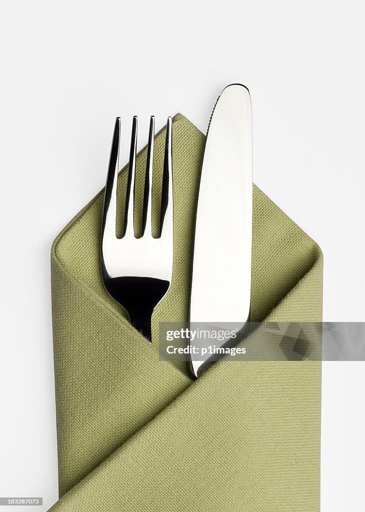 Knife and fork in a green napkin
