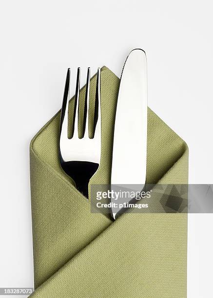 knife and fork in a green napkin - napkin stock pictures, royalty-free photos & images