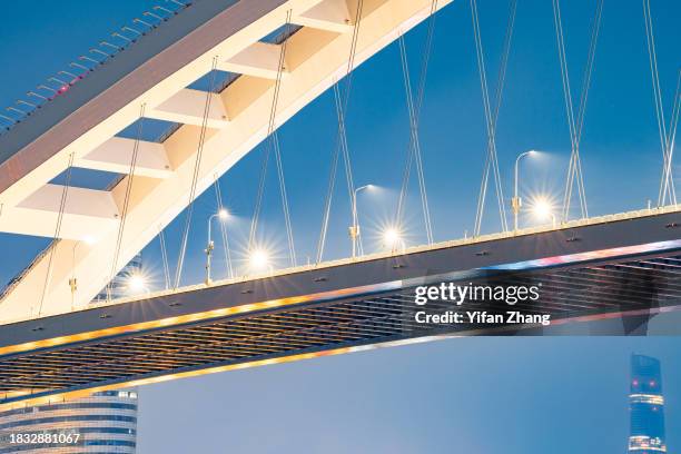 close-up view of cable-stayed lupu bridge illuminated at night - arch bridge stock pictures, royalty-free photos & images