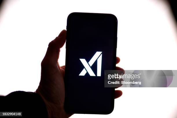 The xAI logo on a smartphone arranged in New York, US, on Thursday, Dec. 7, 2023. Elon Musk's artificial intelligence company xAI is seeking to raise...