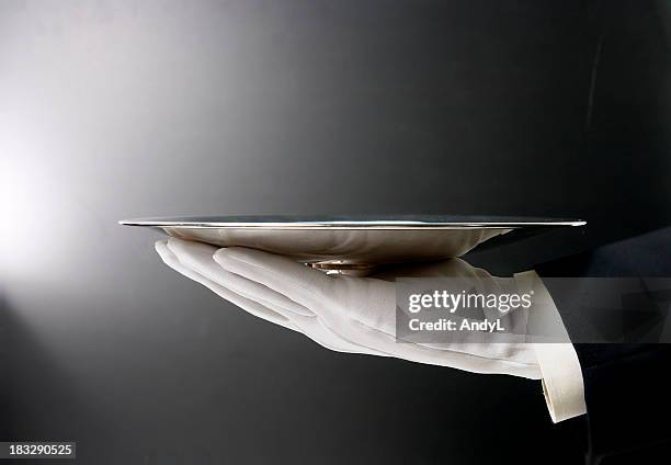 butler serving empty tray on black - silver platter stock pictures, royalty-free photos & images