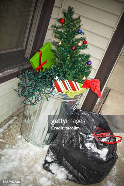 after christmas - xmas tree in the trash - unwanted present stock pictures, royalty-free photos & images