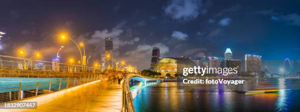 singapore busy esplanade around marina bay illuminated night panorama - merlion park singapore stock pictures, royalty-free photos & images