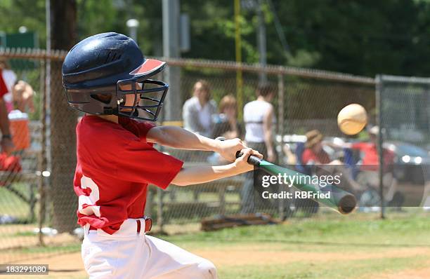 youth league batter - swinging stock pictures, royalty-free photos & images