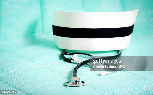 stethoscope and nurse cap on green background - medical symbol - nurse hat stock pictures, royalty-free photos & images