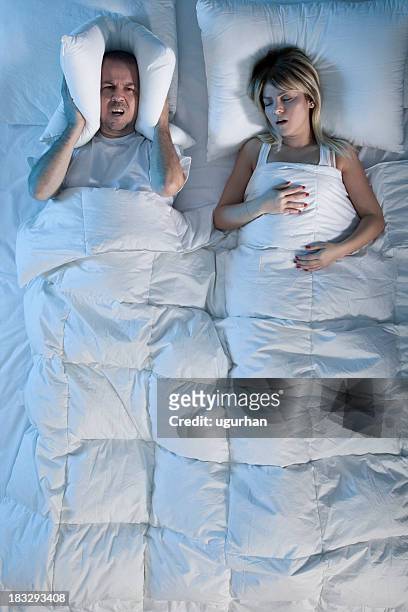 sleeping couple - snoring husband stock pictures, royalty-free photos & images