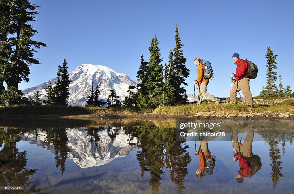 Two men hiking with Mt. Rainier in the background