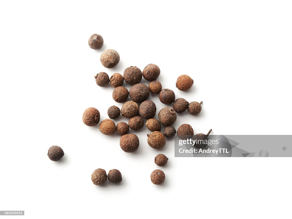 Scattered allspice isolated against a white background
