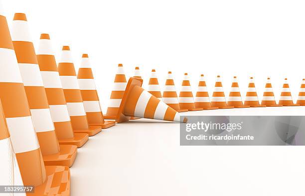 curved line of orange traffic cones with one knocked over - pylons stockfoto's en -beelden
