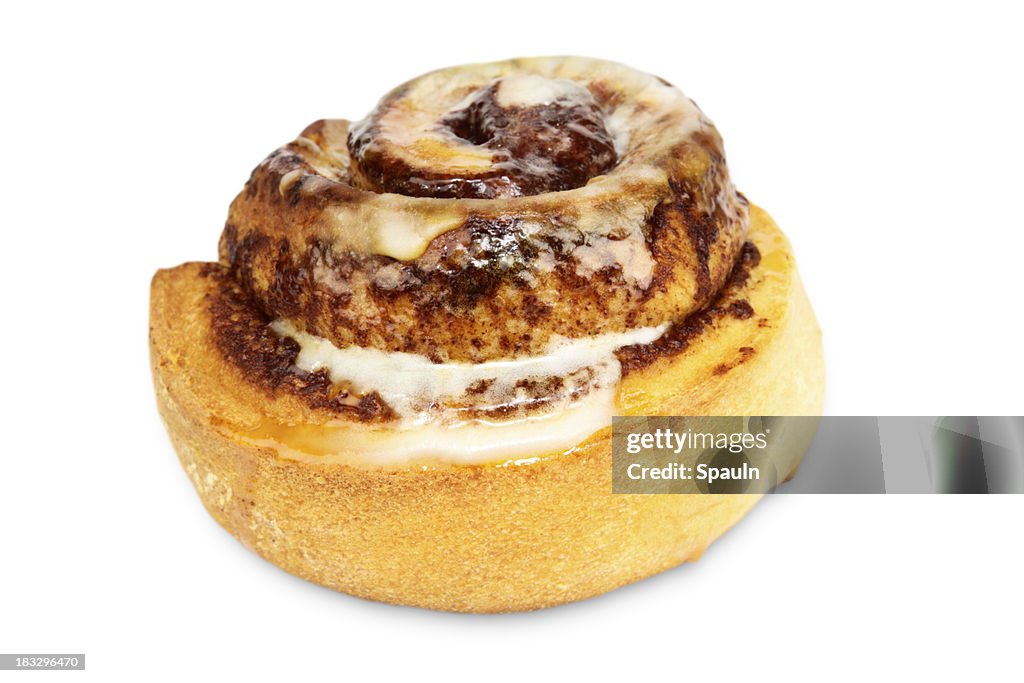 A tasty cinnamon bun with icing on a white background