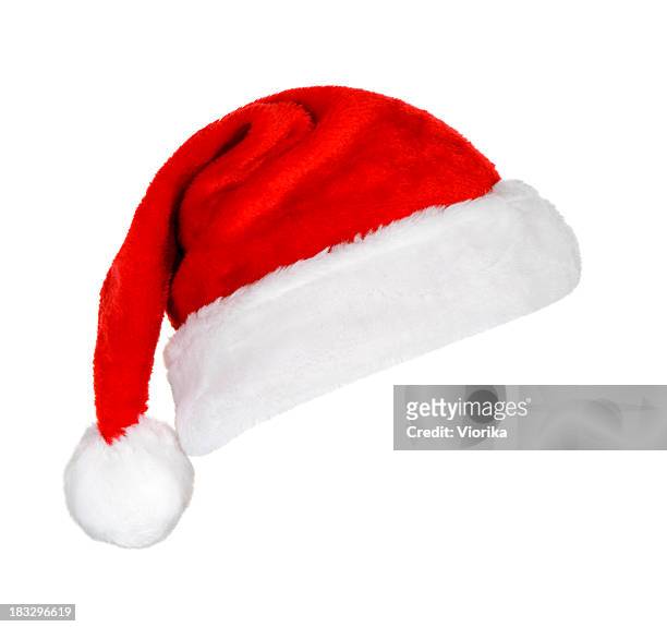 a festive red and white santa hat on a white background - hat stock pictures, royalty-free photos & images