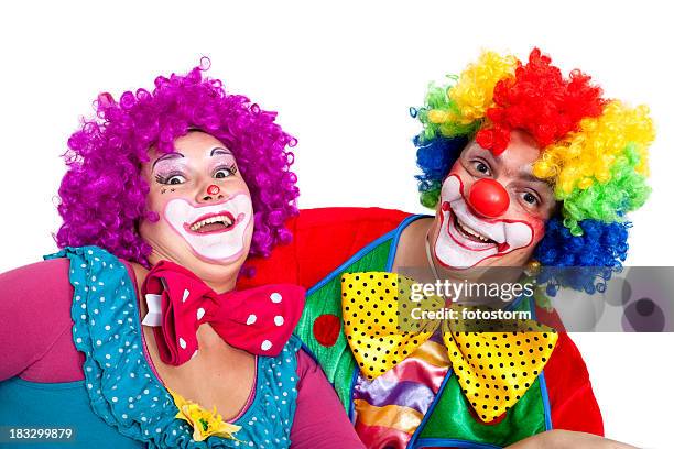 two happy clowns making faces on white background - a fool stock pictures, royalty-free photos & images