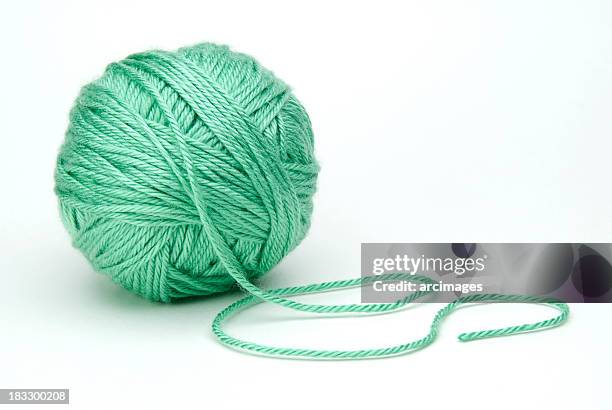 green ball of yarn on white background - yarn stock pictures, royalty-free photos & images