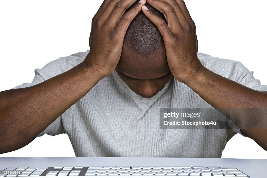 Discouraged man sitting in front of a computer